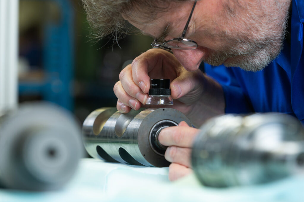 Employee (production) Spikker Specials checks the quality of a critical machine component with extreme precision